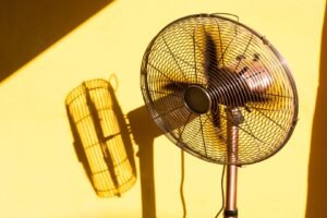 Vintage fan and its shadow from sunlight through the window.